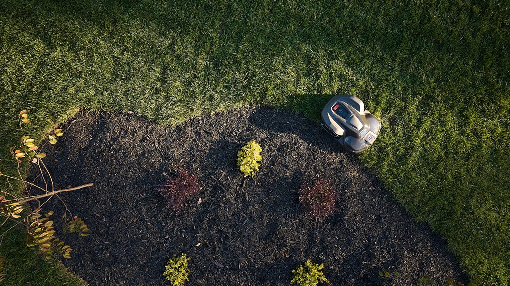 Husqvarna Automower 440 iQ robotic lawn mower navigating a large, complex residential lawn, available at Grafton Power Products in the Clarence Valley.
